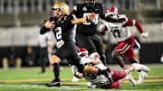 Nov 9, 2024; Nashville, Tennessee, USA;  Vanderbilt Commodores quarterback Diego Pavia (2) breaks the tackle of South Carolina Gamecocks defensive tackle T.J. Sanders (90) during the second half at FirstBank Stadium. Mandatory Credit: Steve Roberts-Imagn Images