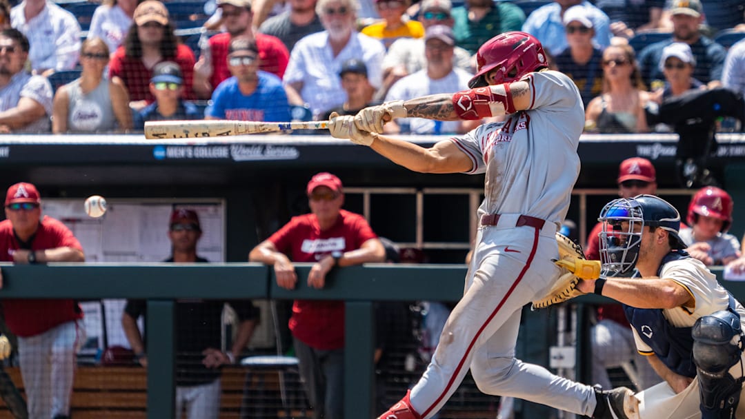 Jun 16, 2025; Omaha, Neb, USA; Arkansas Razorbacks designated hitter Wehiwa Aloy (9) hits a RBI double against the Murray State Racers during the seventh inning at Charles Schwab Field. 