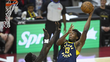 Oct 10, 2024; Cleveland, Ohio, USA; Indiana Pacers center James Wiseman (13) shoots beside Cleveland Cavaliers forward JT Thor (15) in the fourth quarter at Rocket Mortgage FieldHouse. Mandatory Credit: David Richard-Imagn Images