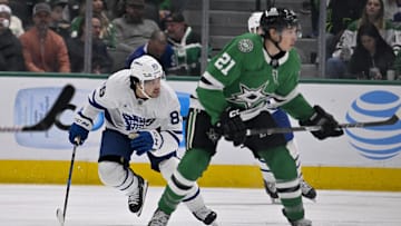 Dec 18, 2024; Dallas, Texas, USA; Toronto Maple Leafs left wing Nicholas Robertson (89) and Dallas Stars left wing Jason Robertson (21) chase the puck during the first period at the American Airlines Center. Mandatory Credit: Jerome Miron-Imagn Images