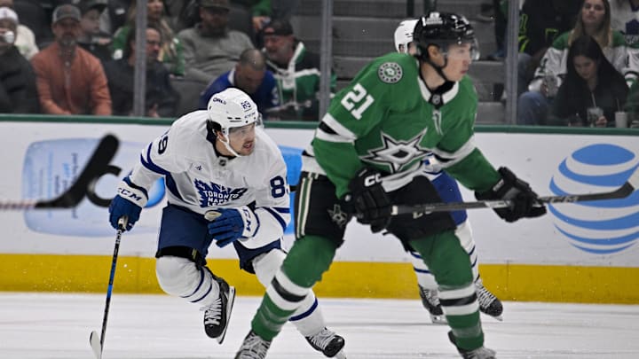 Dec 18, 2024; Dallas, Texas, USA; Toronto Maple Leafs left wing Nicholas Robertson (89) and Dallas Stars left wing Jason Robertson (21) chase the puck during the first period at the American Airlines Center. Mandatory Credit: Jerome Miron-Imagn Images