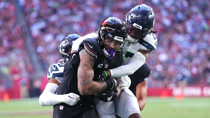 Seattle Seahawks cornerback Riq Woolen tackles Arizona Cardinals running back James Conner.