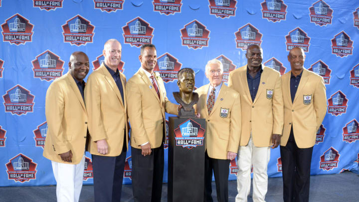 Aug 2, 2014; Canton, OH, USA; Buffalo Bills hall of fame members pose with the bust of Andre Reed at the 2014 Pro Football Hall of Fame Enshrinement at Fawcett Stadium. From left: Thurman Thomas and Jim Kelly and Reed and Marv Levy and Bruce Smith and James Lofton and Billy Shaw. 