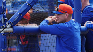 Feb 13, 2025; Port St. Lucie, FL, USA; New York Mets manager Carlos Mendoza (64) watches batting practice during Spring Training. Mandatory Credit: Jim Rassol-Imagn Images