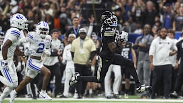 Dec 28, 2024; San Antonio, TX, USA; Colorado Buffaloes wide receiver Travis Hunter (12) runs with the ball during the second quarter against the Brigham Young Cougars at Alamodome. Mandatory Credit: Troy Taormina-Imagn Images