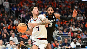 Mar 21, 2025; Milwaukee, WI, USA: Illinois Fighting Illini forward Will Riley (7) drives to the hoop past Xavier Musketeers forward Jerome Hunter (2) during the second half at Fiserv Forum. Mandatory Credit: Benny Sieu-Imagn Images