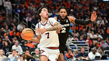 Mar 21, 2025; Milwaukee, WI, USA: Illinois Fighting Illini forward Will Riley (7) drives to the hoop past Xavier Musketeers forward Jerome Hunter (2) during the second half at Fiserv Forum. Mandatory Credit: Benny Sieu-Imagn Images