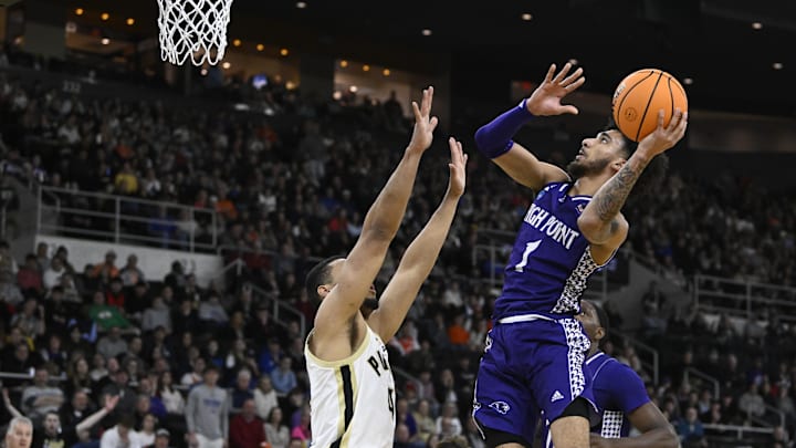 Mar 20, 2025; Providence, RI, USA; High Point Panthers guard Kezza Giffa (1) shoots the ball over Purdue Boilermakers forward Trey Kaufman-Renn (4) during the first half at Amica Mutual Pavilion. Mandatory Credit: Eric Canha-Imagn Images