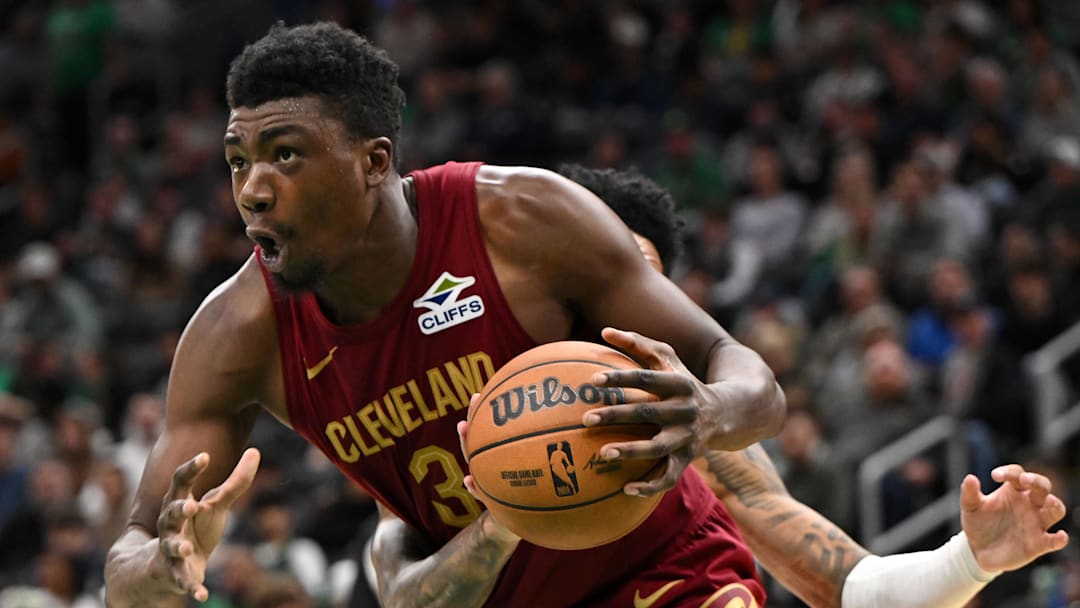 Oct 12, 2025; Boston, Massachusetts, USA; Boston Celtics guard Anfernee Simons (4) defends Cleveland Cavaliers center/forward Thomas Bryant (3) during the second half at TD Garden. Mandatory Credit: Brian Fluharty-Imagn Images