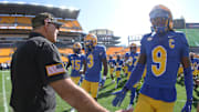 Oct 4, 2025; Pittsburgh, Pennsylvania, USA;  Pittsburgh Panthers head coach Pat Narduzzi (left) greets linebacker Kyle Louis (9) as the team takes the field to warm up before the game against the Boston College Eagles at Acrisure Stadium. Mandatory Credit: Charles LeClaire-Imagn Images