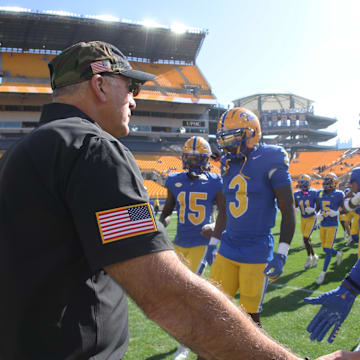 Oct 4, 2025; Pittsburgh, Pennsylvania, USA;  Pittsburgh Panthers head coach Pat Narduzzi (left) greets linebacker Kyle Louis (9) as the team takes the field to warm up before the game against the Boston College Eagles at Acrisure Stadium. Mandatory Credit: Charles LeClaire-Imagn Images