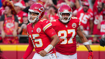 Sep 15, 2024; Kansas City, Missouri, USA; Kansas City Chiefs quarterback Patrick Mahomes (15) and tight end Travis Kelce (87) return to the sidelines after a score against the Cincinnati Bengals during the first half at GEHA Field at Arrowhead Stadium. Mandatory Credit: Denny Medley-Imagn Images