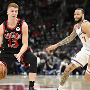Feb 26, 2025; Chicago, Illinois, USA;  Chicago Bulls guard Kevin Huerter (13) moves the ball past LA Clippers guard Amir Coffey (7) during the second half  at the United Center. Mandatory Credit: Matt Marton-Imagn Images