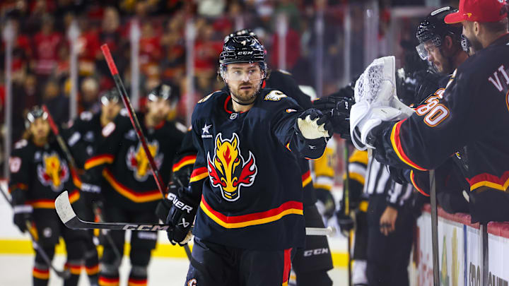 Oct 22, 2024; Calgary, Alberta, CAN; Calgary Flames defenseman Rasmus Andersson (4) celebrates his goal with teammates against the Pittsburgh Penguins during the first period at Scotiabank Saddledome. Mandatory Credit: Sergei Belski-Imagn Images Oct 22, 2024; Calgary, Alberta, CAN; Calgary Flames defenseman Rasmus Andersson (4) celebrates his goal with teammates against the Pittsburgh Penguins during the first period at Scotiabank Saddledome. Mandatory Credit: Sergei Belski-Imagn Images
