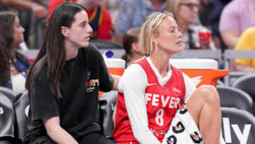 Indiana Fever guard Caitlin Clark (22) and guard Sophie Cunningham (8) watch from the bench during the first half of a game against the Washington Mystics on Friday, Aug. 15, 2025, at Gainbridge Fieldhouse in Indianapolis.