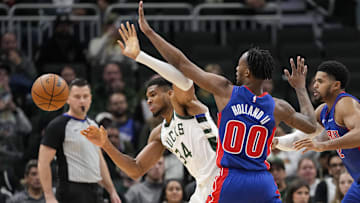 Nov 13, 2024; Milwaukee, Wisconsin, USA;  Detroit Pistons forward Ron Holland II (00) knocks the ball away from Milwaukee Bucks forward Giannis Antetokounmpo (34): Jeff Hanisch-Imagn Images