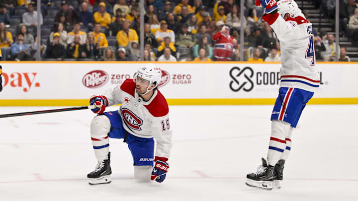 Mar 28, 2026; Nashville, Tennessee, USA;  Montreal Canadiens defenseman Alexandre Carrier (45) celebrates the goal of center Alex Newhook (15) against the Nashville Predators during the second period Gat Bridgestone Arena. Mandatory Credit: Steve Roberts-Imagn Images