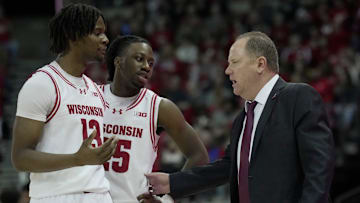 Wisconsin head coach Greg Gard talks two forward Xavier Amos (13) and guard John Blackwell (25) during the second half of their game Sunday, December 22, 2024 at the Kohl Center in Madison, Wisconsin. Wisconsin beat Detroit Mercy 76-53.