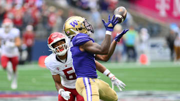 Sep 14, 2024; Seattle, Washington, USA; Washington Huskies wide receiver Giles Jackson (5) catches a pass over Washington State Cougars defensive back Tyson Durant (5) during the second half at Lumen Field. Mandatory Credit: Steven Bisig-Imagn Images