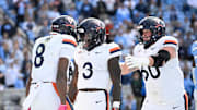 Oct 25, 2025; Chapel Hill, North Carolina, USA; Virginia Cavaliers running back J'Mari Taylor (3) celelbrates with wide receiver Jayden Thomas (8) and center Drake Metcalf (60) after scoring a touchdown in overtime at Kenan Stadium. Mandatory Credit: Bob Donnan-Imagn Images