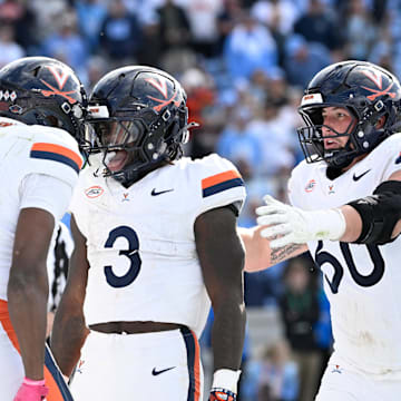 Oct 25, 2025; Chapel Hill, North Carolina, USA; Virginia Cavaliers running back J'Mari Taylor (3) celelbrates with wide receiver Jayden Thomas (8) and center Drake Metcalf (60) after scoring a touchdown in overtime at Kenan Stadium. Mandatory Credit: Bob Donnan-Imagn Images