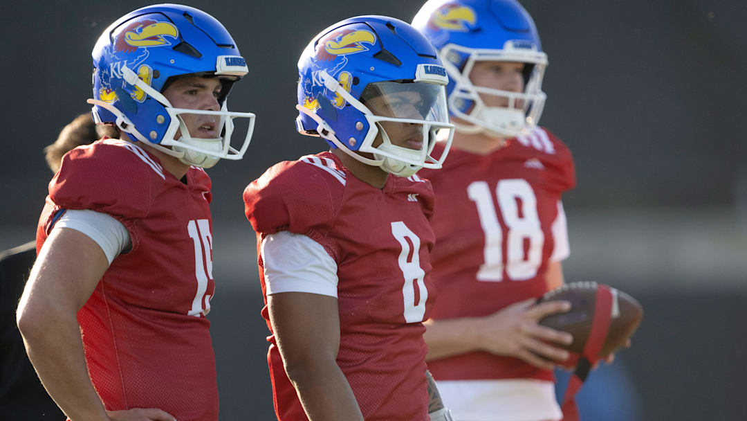 Kansas redshirt junior quarterback Cole Ballard (15) and Isaiah Marshall (8) watch during spring football practice Thursday, Mar. 26, 2026 in Lawrence, Kansas.