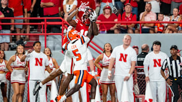 Sep 20, 2024; Lincoln, Nebraska, USA; Illinois Fighting Illini defensive back Torrie Cox Jr. (5) intercepts a pass to Nebraska Cornhuskers wide receiver Isaiah Neyor (18) during the second quarter at Memorial Stadium. Mandatory Credit: Dylan Widger-Imagn Images