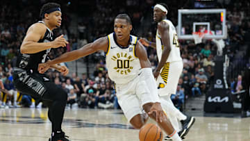 Mar 3, 2024; San Antonio, Texas, USA; Indiana Pacers guard Bennedict Mathurin (00) dribbles past San Antonio Spurs forward Keldon Johnson (3) in the first half at Frost Bank Center. Mandatory Credit: Daniel Dunn-Imagn Images