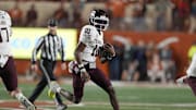 Nov 28, 2025; Austin, Texas, USA; Texas A&M Aggies quarterback Marcel Reed (10) keeps the ball for yards during the first half against the Texas Longhorns at Darrell K Royal-Texas Memorial Stadium. Mandatory Credit: Scott Wachter-Imagn Images