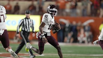 Nov 28, 2025; Austin, Texas, USA; Texas A&M Aggies quarterback Marcel Reed (10) keeps the ball for yards during the first half against the Texas Longhorns at Darrell K Royal-Texas Memorial Stadium. Mandatory Credit: Scott Wachter-Imagn Images