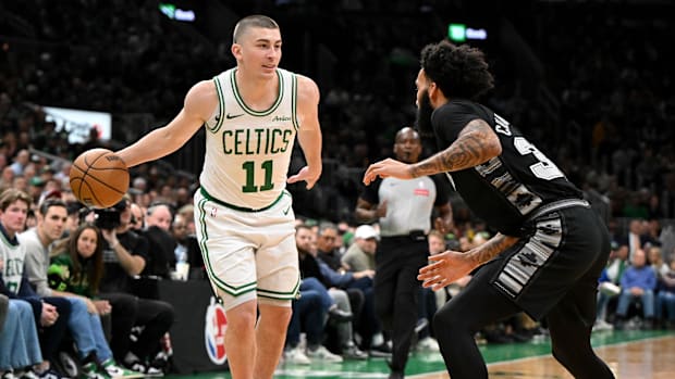 Boston Celtics guard Payton Pritchard (11) drives to the basket against San Antonio Spurs forward Julian Champagnie (30)