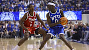 Mar 8, 2025; Provo, Utah, USA; Brigham Young Cougars forward Mawot Mag (0) looks to pass against Utah Utes forward Ezra Ausar (2) during the second half at Marriott Center. Mandatory Credit: Rob Gray-Imagn Images