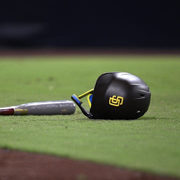 Aug 22, 2023; San Diego, California, USA; A detailed view of a San Diego Padres helmet and bat in the field during the seventh inning against the Miami Marlins at Petco Park. Mandatory Credit: Orlando Ramirez-Imagn Images