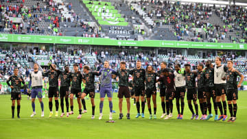 Bayern Munich squad celebrating in front of fans after beating Wolfsburg on matchday one of the Bundesliga.