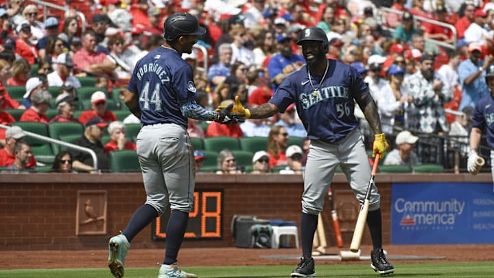 Seattle Mariners center fielder Julio Rodriguez and left fielder Randy Arozarena interact during a game against the St. Louis Cardinals on Sunday at Busch Stadium.