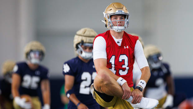 Riley Leonard stretches before the first Notre Dame football fall camp practice of 2024.  