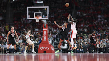 Nov 14, 2025; Houston, Texas, USA: Portland Trail Blazers guard Jrue Holiday (5) shoots the ball as Houston Rockets forward Jabari Smith Jr. (10) defends during the second quarter at Toyota Center. Mandatory Credit: Troy Taormina-Imagn Images