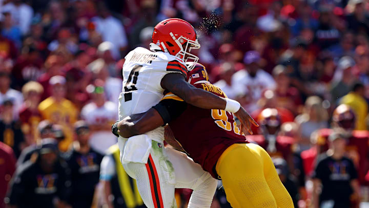 Oct 6, 2024; Landover, Maryland, USA; Cleveland Browns quarterback Deshaun Watson (4) is hit by Washington Commanders defensive end Dorance Armstrong (92) while throwing the ball during the second quarter at NorthWest Stadium. Mandatory Credit: Peter Casey-Imagn Images