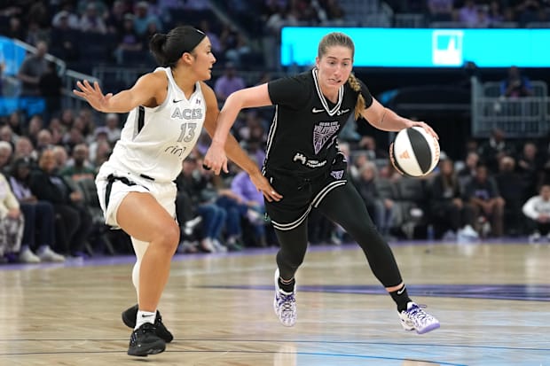 Golden State Valkyries guard Kate Martin dribbles against Las Vegas Aces guard Aaliyah Nye.