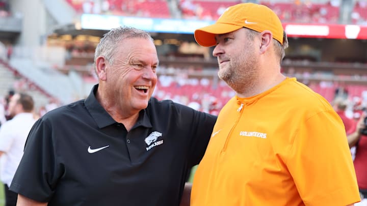 Oct 5, 2024; Fayetteville, Arkansas, USA; Arkansas Razorbacks head coach Sam Pittman talks to Tennessee Volunteers head coach Josh Heupel before the game at Donald W. Reynolds Razorback Stadium.