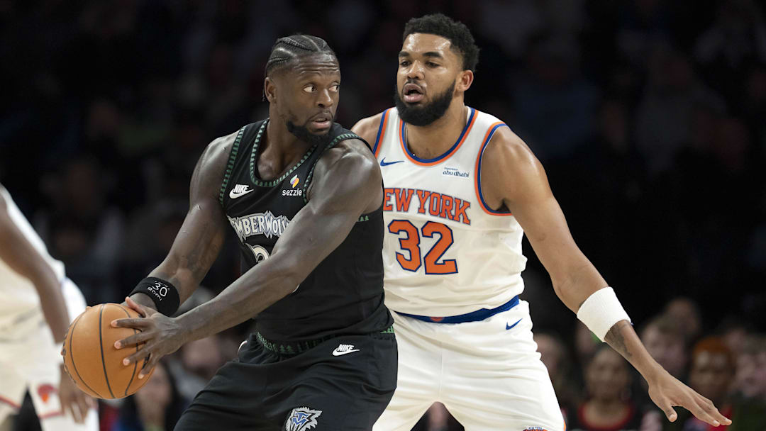 Dec 23, 2025; Minneapolis, Minnesota, USA; Minnesota Timberwolves forward Julius Randle (30) holds the ball as New York Knicks center Karl-Anthony Towns (32) plays defense in the first half at Target Center. Mandatory Credit: Jesse Johnson-Imagn Images