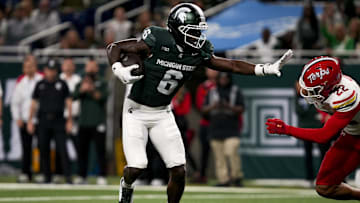 Nov 29, 2025; Detroit, Michigan, USA; Michigan State wide receiver Nick Marsh (6) stiff arms Maryland defensive back Jalen Huskey (22) in the second quarter at Ford Field. Mandatory Credit: Brendan Mullin-Imagn Images