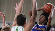 Bremerton's Jalen Davis hoots over a pair of Lynden defenders during last year's 2A tournament in the Yakima Valley SunDome.