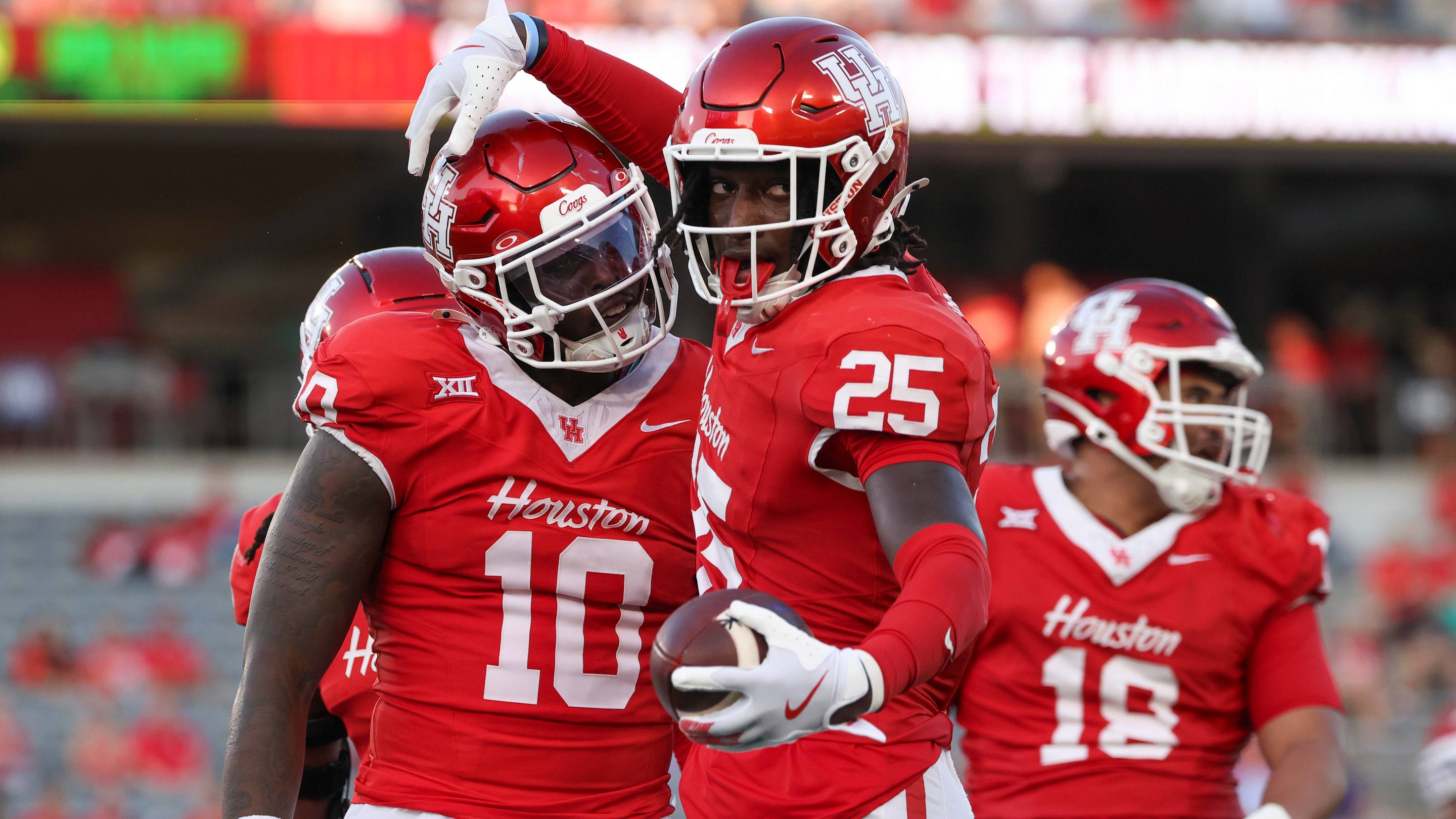 Aug 28, 2025; Houston, Texas, USA; Houston Cougars linebacker Latreveon McCutchin (10) celebrates with linebacker Carmycah Glass (25) after a play during the first quarter against the Stephen F. Austin Lumberjacks at TDECU Stadium. Mandatory Credit: Troy Taormina-Imagn Images | IMAGN IMAGES via Reut