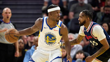 Apr 13, 2025; San Francisco, California, USA; Golden State Warriors forward Jimmy Butler III (10) dribbles the ball against LA Clippers forward Derrick Jones Jr. (55) as referee Jacyn Goble (68) watches the play during the fourth quarter at Chase Center. Mandatory Credit: Robert Edwards-Imagn Images