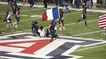 Nov 14, 2015; Tucson, AZ, USA; Arizona Wildcats place kicker Casey Skowron (41) runs onto the field with the French flag before the game against the Utah Utes at Arizona Stadium. Mandatory Credit: Casey Sapio-Imagn Images