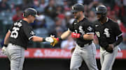 Chicago White Sox first baseman Andrew Vaughn (25) celebrates with left fielder Andrew Benintendi (23) and center fielder Luis Robert Jr. (88) at Angel Stadium. 