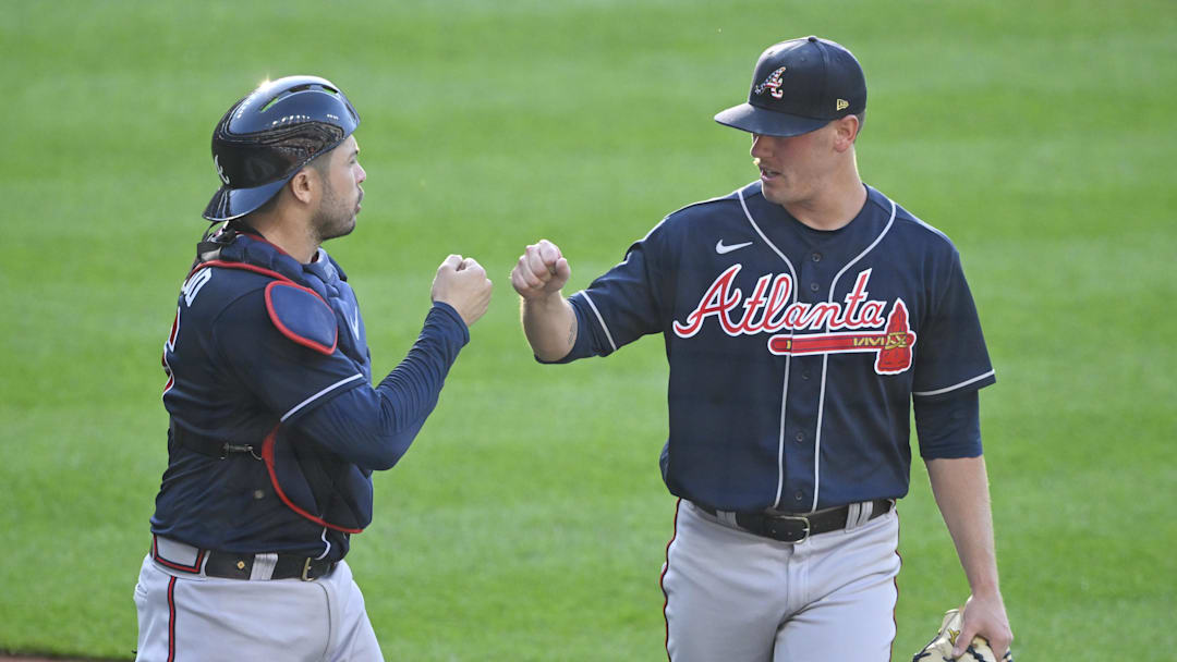 Jul 4, 2023; Cleveland, Ohio, USA; Atlanta Braves catcher Travis d'Arnaud (16) and starting pitcher Kolby Allard (49) celebrate in the second inning against the Cleveland Guardians at Progressive Field. Mandatory Credit: David Richard-Imagn Images