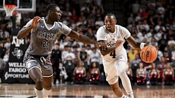 Nov 8, 2024; College Station, Texas, USA; Texas A&M Aggies guard Wade Taylor IV (4) dribbles the ball against East Texas A&M Lions forward KC Ugwuakazi (21) at Reed Arena. The Aggies defeated the Lions 87-55. Mandatory Credit: Maria Lysaker-Imagn Images 