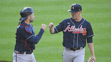 Jul 4, 2023; Cleveland, Ohio, USA; Atlanta Braves catcher Travis d'Arnaud (16) and starting pitcher Kolby Allard (49) celebrate in the second inning against the Cleveland Guardians at Progressive Field. Mandatory Credit: David Richard-Imagn Images